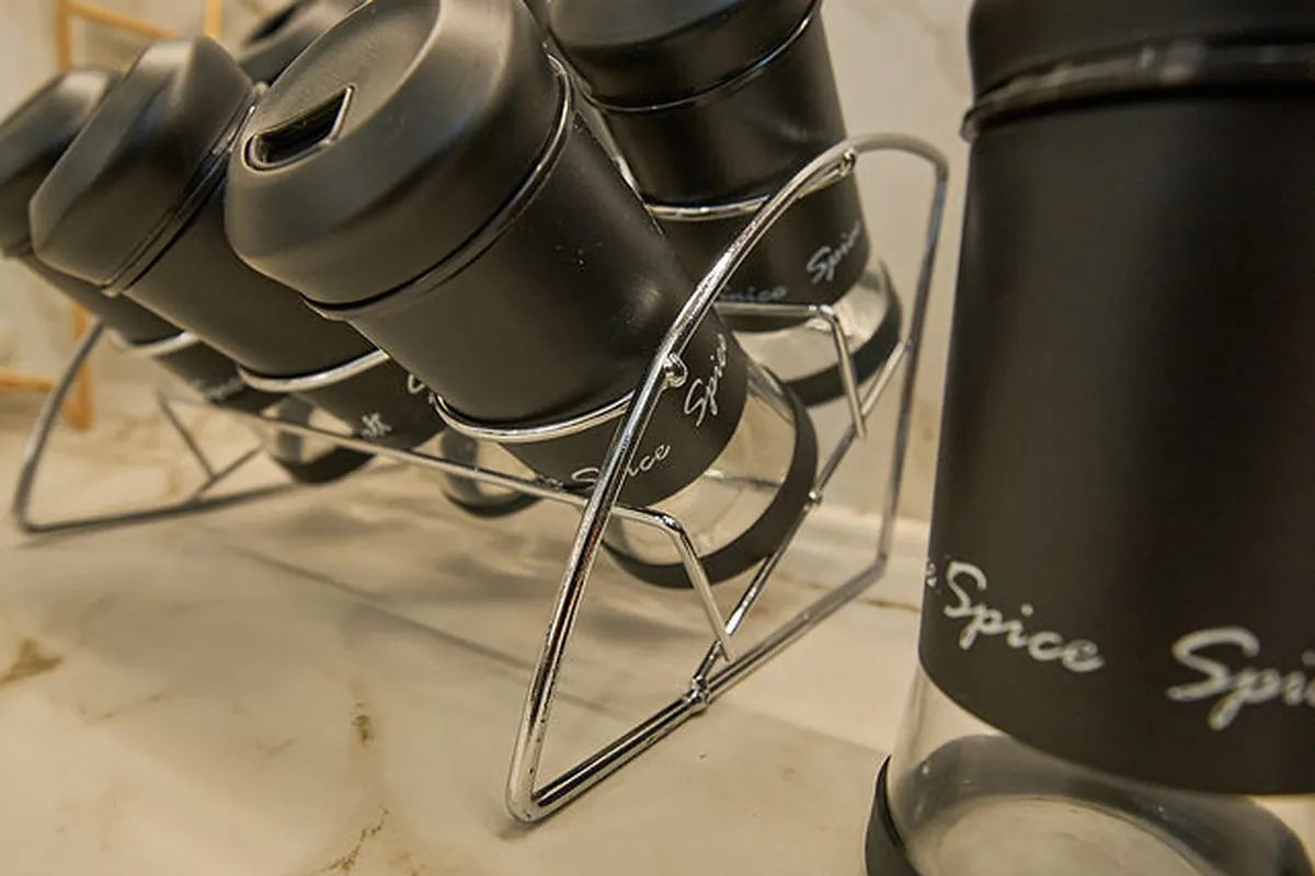 Open-plan living area with sculptural furniture composition and layered textile accents