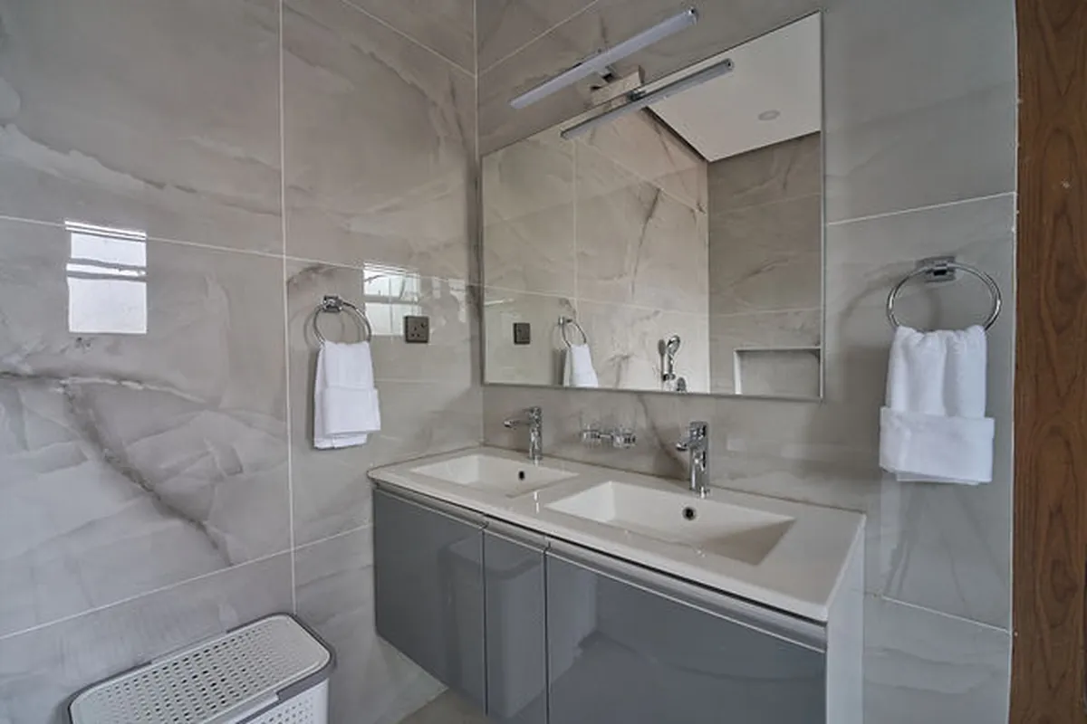 Bedroom suite with soft boucle textures and ambient bedside lighting